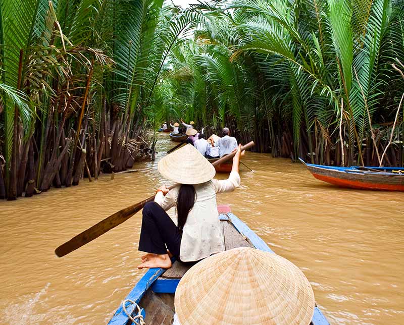 Paddling in the river. Vietnam, Asia.