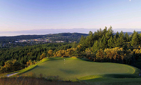 Golf course with green forest and mountains. BC, Canada.